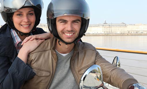 man and woman on a motorcycle